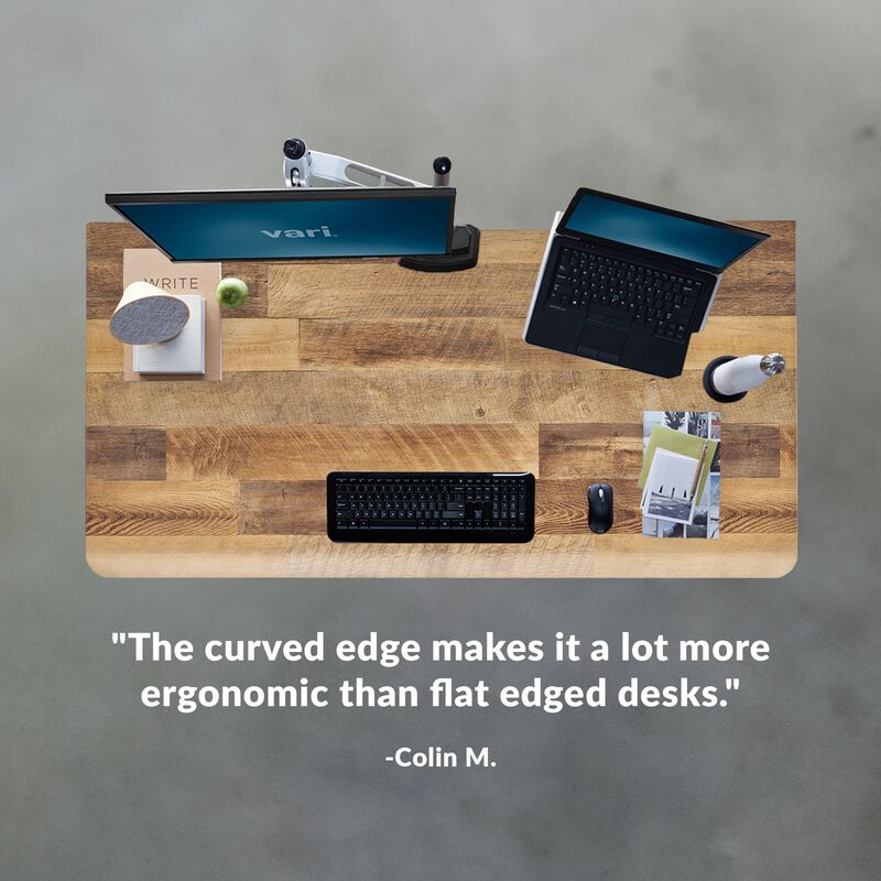 colin m. stated the curved edge makes it a lot more ergonomic than flat edged desks under an overhead image of a desk image number null